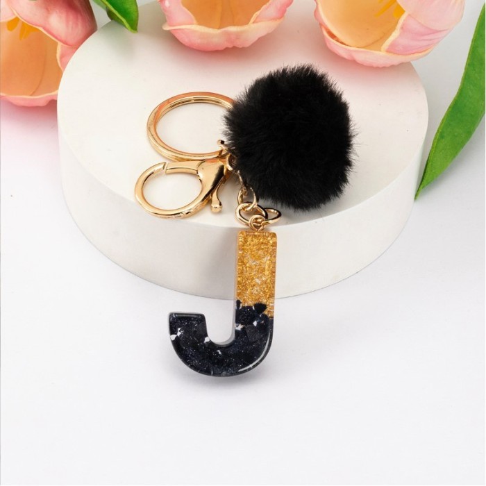 Brelok do kluczy LITERKA J, czarno-złota z pomponem, żywica